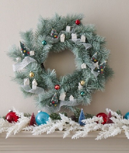 greenery wreath and garland on white mantel 
