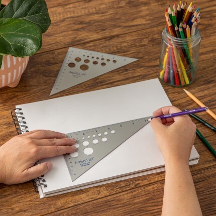 Drawing tool on paper with person utilizing the straight end