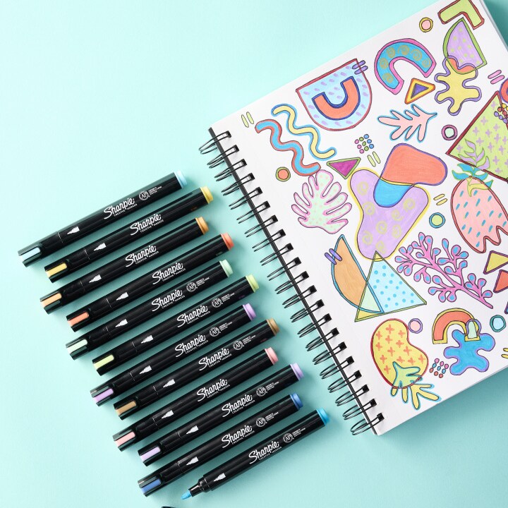 makers sitting on a white pae of a sketchbook