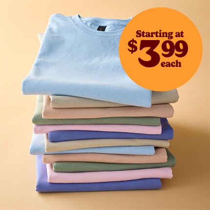 stack of brightly colored t-shirts in reverse rainbow order