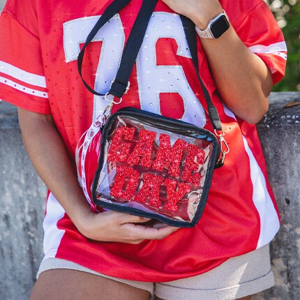 game day bag and woman wearing red and white jersey