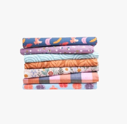 stack of folded fabric in assorted patterns