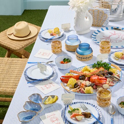 blue and white coastal themed table with seafood dishes