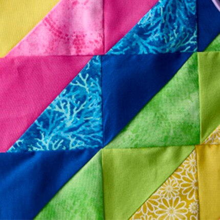 close up image of quilted triangles in bright colors