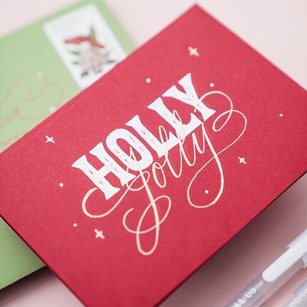 red handmade holiday card with Holly Jolly in white script