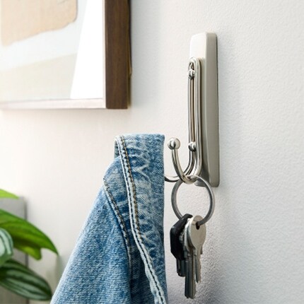 Denim jacket and keys on a wall command hook