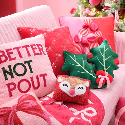 Berry Jolly decor pink, red & green pillow decor with blanket on a couch