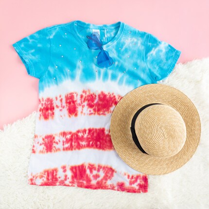 red white & blue tie die shirt with a hat