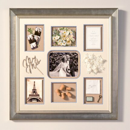 brushed silver frame with wedding photos and mementos with formatted cream matte