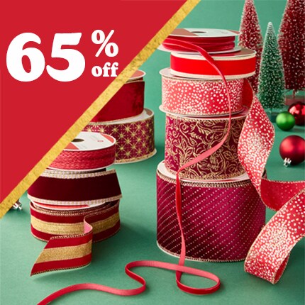 stacked spools of red decorative ribbon with 75 % off in white text over red triangle