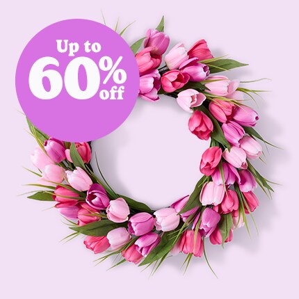 Easter wreath with floral and eggs and egg garland on a mantle 