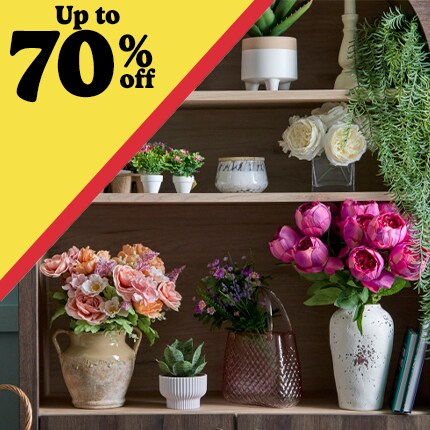 wood shelving decorated with ceramic vases with pink flower, succulent sand greenery