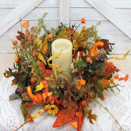 Fall colored floral around a candle