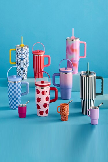 drink tumblers in assorted sizes with bright colors and patterns on blue background