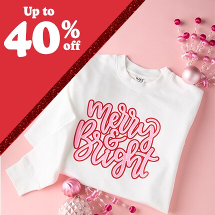 white sweatshirt with merry & bright in pink letters with up to 40% off in white text in red triangle