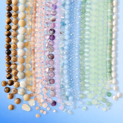 red, green and blue assorted beads in rainbow order on red background
