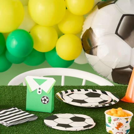 soccer balloon with table full of soccer plates and striped napkins