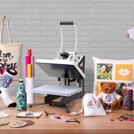 white sublimation heat press with supplies on wood table