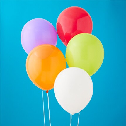 purple, red, orange, yellow and white latex balloons on blue background
