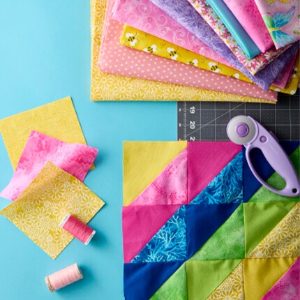 quilt fabric squares with template and rotary scissors 