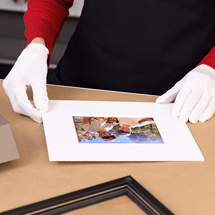A Michaels employee working on a frame.