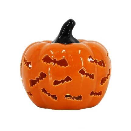 orange ceramic pumpkin with bat shaped cutouts