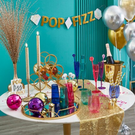 Holiday baking supplies and cookie cutters on a baking sheet with The Party Shop logo