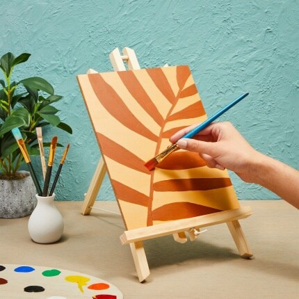 handing panting leaf on canvas