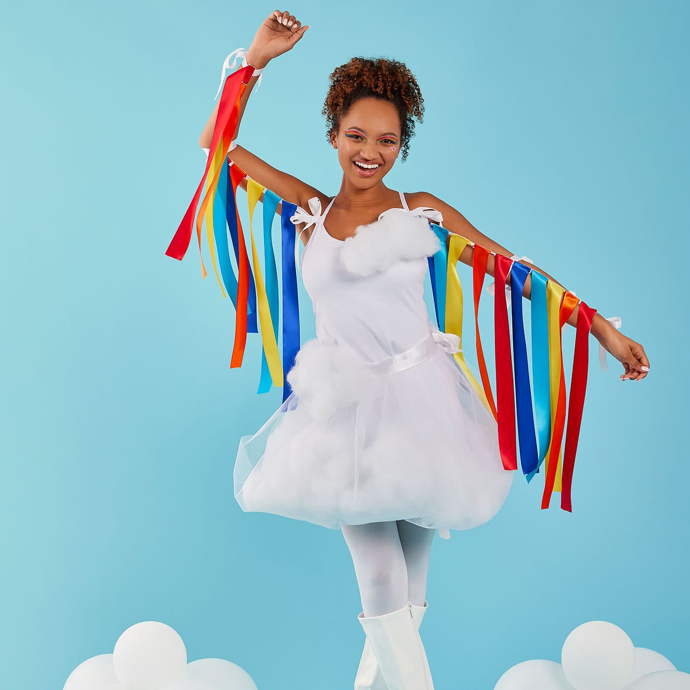 A woman wearing white clothes with rainbow ribbons