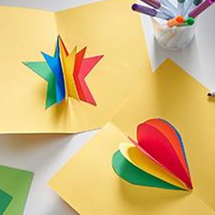 3D shapes burst from folded paper