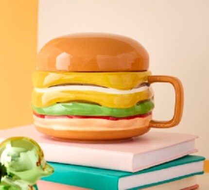 cheeseburger mug on books