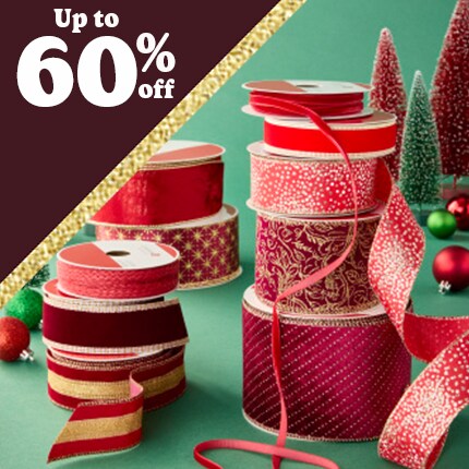 stacked spools of red decorative ribbon with 75 % off in white text over red triangle