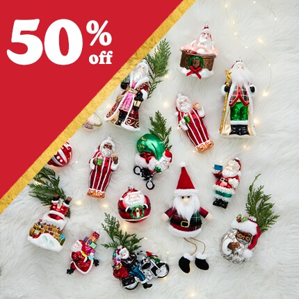 decorative ornaments laid out in fake snow with 50% off in white text over red triangle