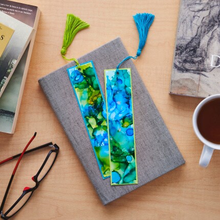 gray book with blue and green bookmarks