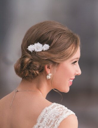 woman with hair updo and white floral accent